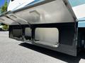 2000 Ford Motorhome with an open storage compartment revealing empty space and items inside