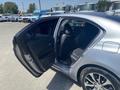 A 2017 Acura TLX with an open rear door revealing black leather seats inside