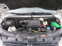 Engine compartment of a 2009 Dodge Sprinter Van featuring various components like the battery coolant reservoir and air intake system