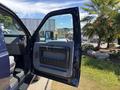 A 2014 Ford F-250 SD with an open driver's side door showing the interior door panel and handle