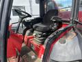 Interior view of a 2014 Toro Groundmaster 5910 featuring a black driver's seat with armrest and a steering wheel on the left side