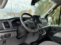 Interior view of a 2022 Ford Transit showing the steering wheel dashboard and infotainment screen