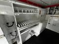 Interior of a 2013 Ford Econoline with open storage compartments and dividers for organizing equipment or supplies