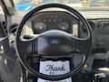 The interior of a 2015 Ford F-750 focusing on the steering wheel dashboard and control panel