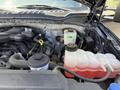 A 2017 Ford F-550 engine compartment showing various components including a coolant reservoir and hoses