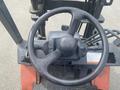 Close-up view of the steering wheel and control panel of a 2010 Toyota 7FGGU25 forklift