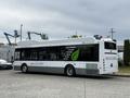 A 2018 Grande West Vicinity bus with a white and green design featuring text about its features powered by compressed natural gas