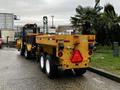 A yellow 2015 International 3000 MT6 truck with a dump bed attached parked on a pavement