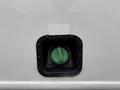 Close-up of a green fuel cap with a black cover on a 2011 Ford F-550