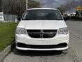 A white 2011 Dodge Grand Caravan with a black grille and visible headlights positioned front facing