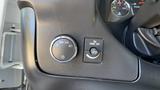 A close-up view of the controls on the dashboard of a 2011 Chevrolet Express including the headlight and fog light switches