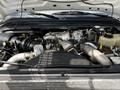 Engine compartment of a 2009 Ford F-550 featuring a Power Stroke V8 turbo diesel engine with various components including hoses and an air intake system