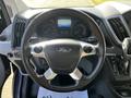 The image shows the steering wheel and dashboard of a 2017 Ford Transit with controls and a display screen in the center