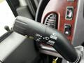 A close-up of the turn signal and headlight control stalk from a 2006 Freightliner M2 112 featuring labeled buttons for off push and pull flash functions