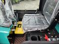 Interior view of a 2024 AGT Industrial Green QH13R Mini Excavator featuring a covered seat control levers and operational controls