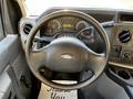 View of the dashboard and steering wheel of a 2017 Ford Econoline with various gauges and controls visible