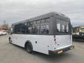 A 2017 Chevrolet Express bus with a gray and white exterior featuring large windows and a rounded rear design