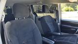 Interior of a 2016 Dodge Grand Caravan showing two front seats with fabric upholstery and armrests