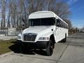 2022 Blue Bird Vision school bus with a white exterior and large front windshield parked on a roadway