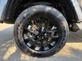 Black alloy wheel of a 2021 Jeep Gladiator with Goodyear Wrangler tire showcasing a five-spoke design and visible lug nuts