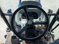 The steering wheel and dashboard controls of a 2018 New Holland Boomer 45 tractor with various buttons and gauges visible