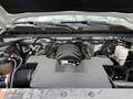 The engine compartment of a 2017 Chevrolet Silverado 1500 featuring a black air intake manifold and various engine components