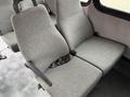 A pair of gray upholstered seats from a 2014 Ford Econoline with seatbelts attached