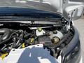 A 2023 Ford Transit engine compartment with visible components including hoses a coolant reservoir and a cap