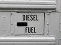 A fuel access door labeled DIESEL FUEL on a 2016 International CE300 vehicle with water droplets on its surface