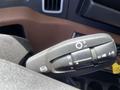 A close-up of the gear shift lever inside a 2022 Freightliner Cascadia showing various settings including neutral drive reverse and light controls