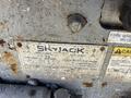 A close-up view of a metal nameplate for a 2010 SkyJack SJ with specifications including model number serial number and machine details