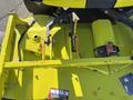 The image shows the yellow underside of a 2010 Kubota F3990 lawn mower with visible blades and pulleys