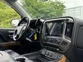 Interior view of a 2017 Chevrolet Silverado 1500 showing the steering wheel and a touchscreen infotainment system on the dashboard
