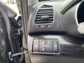 Interior controls of a 2015 Kia Sorento including air vents and various buttons for locking and unlocking the vehicle