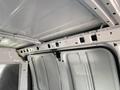 Interior view of a 2012 GMC Savana van showing the ceiling and inner structure with metal framework and a clean white finish