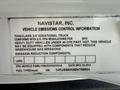 A label featuring vehicle emissions control information for a 2014 International TerraStar truck detailing compliance with EPA regulations and emission reduction components