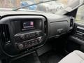 Interior dashboard of a 2015 GMC Sierra 1500 featuring a touchscreen display and climate control buttons