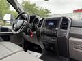 Interior view of a 2022 Ford F600 showing the dashboard steering wheel and infotainment system