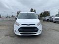 A 2017 Ford Transit Connect van facing forward with a white exterior and a black grille