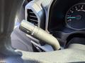 A close-up of the control stalk of a 2018 Ford F-150 featuring wiper and turn signal controls with a speedometer visible in the background