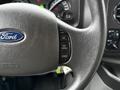 The image shows the steering wheel of a 2014 Ford E-450 featuring buttons for cruise control including settings for resume, set, and coast