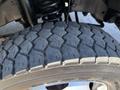 Close-up of a treaded tire from a 2013 Ford F-550 showcasing the detailed pattern and wear on the rubber surface
