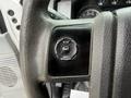 Close-up of the steering wheel of a 2015 Ford F-350 SD with a black control panel featuring buttons labeled Setup Info and Reset