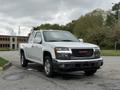 A 2012 GMC Canyon pickup truck with a white exterior and a standard cab design parked on a paved surface