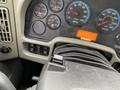 Interior dashboard of a 2014 International Durastar featuring various gauges including RPM speedometer and warning lights along with control buttons
