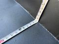 A measuring tape is extended across a surface, showing a right-angle bend at the corner with clear markings and measurements visible