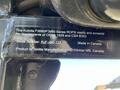 A metal plate featuring information about a 2010 Kubota F3990 tractor including serial number and compliance details