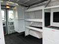 Interior of a 2009 Ford Econoline van featuring shelves and storage compartments along the sides