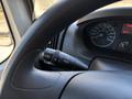 Close-up of the steering wheel and control stalk of a 2016 RAM Promaster showing lighting and wiper controls