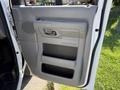 The image shows the interior door panel of a 2011 Ford Econoline featuring a handle and two storage compartments